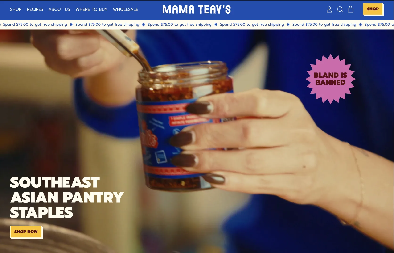 The Mama Teav’s homepage: a saturated blue header with a yellow shop button, a shipping ticker, and a hand lifting chili crisp from a jar beside a pink sticker reading Bland is Banned.